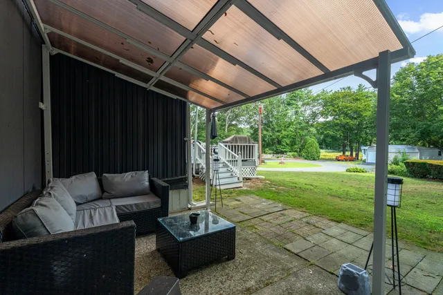 a patio with garden area and furniture