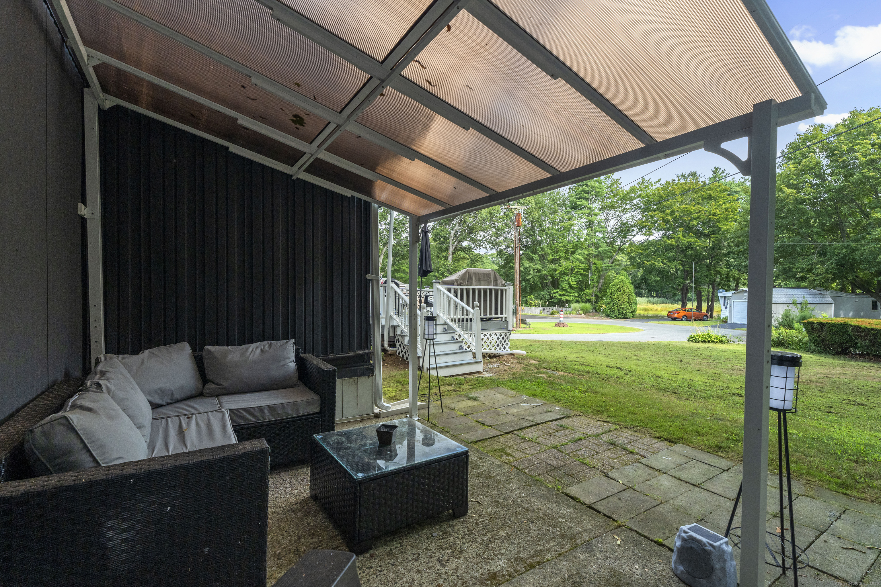 133 West Main Street, Unit MV1 Clinton, CT 06413 - Photo 28 of 36 a patio with garden area and furniture