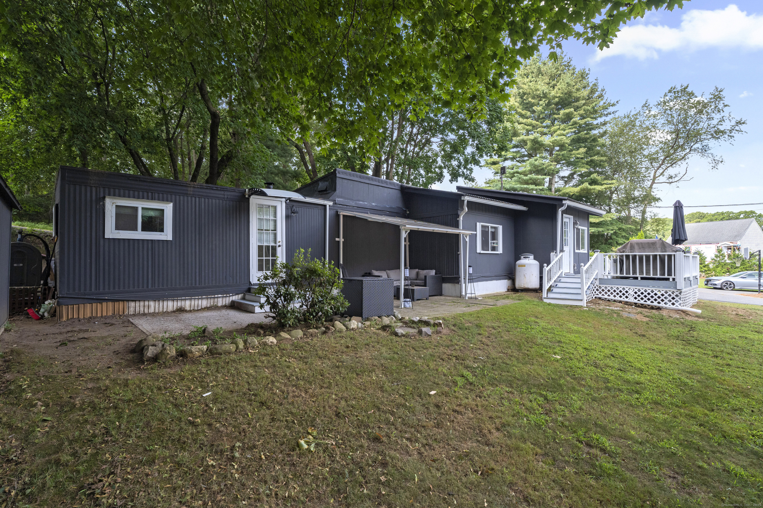 133 West Main Street, Unit MV1 Clinton, CT 06413 - Photo 30 of 36 a front view of house with yard and seating area
