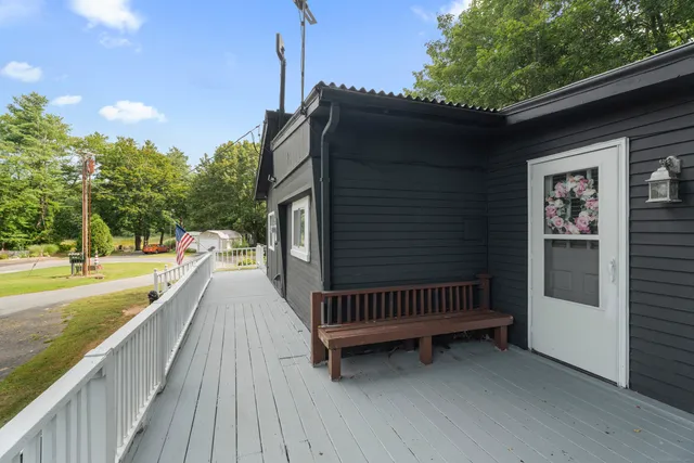 a view of balcony with wooden floor and outdoor seating