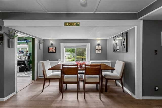 a dining room with furniture and wooden floor