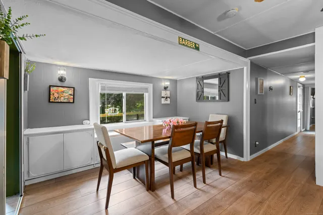 a dining room with furniture and window