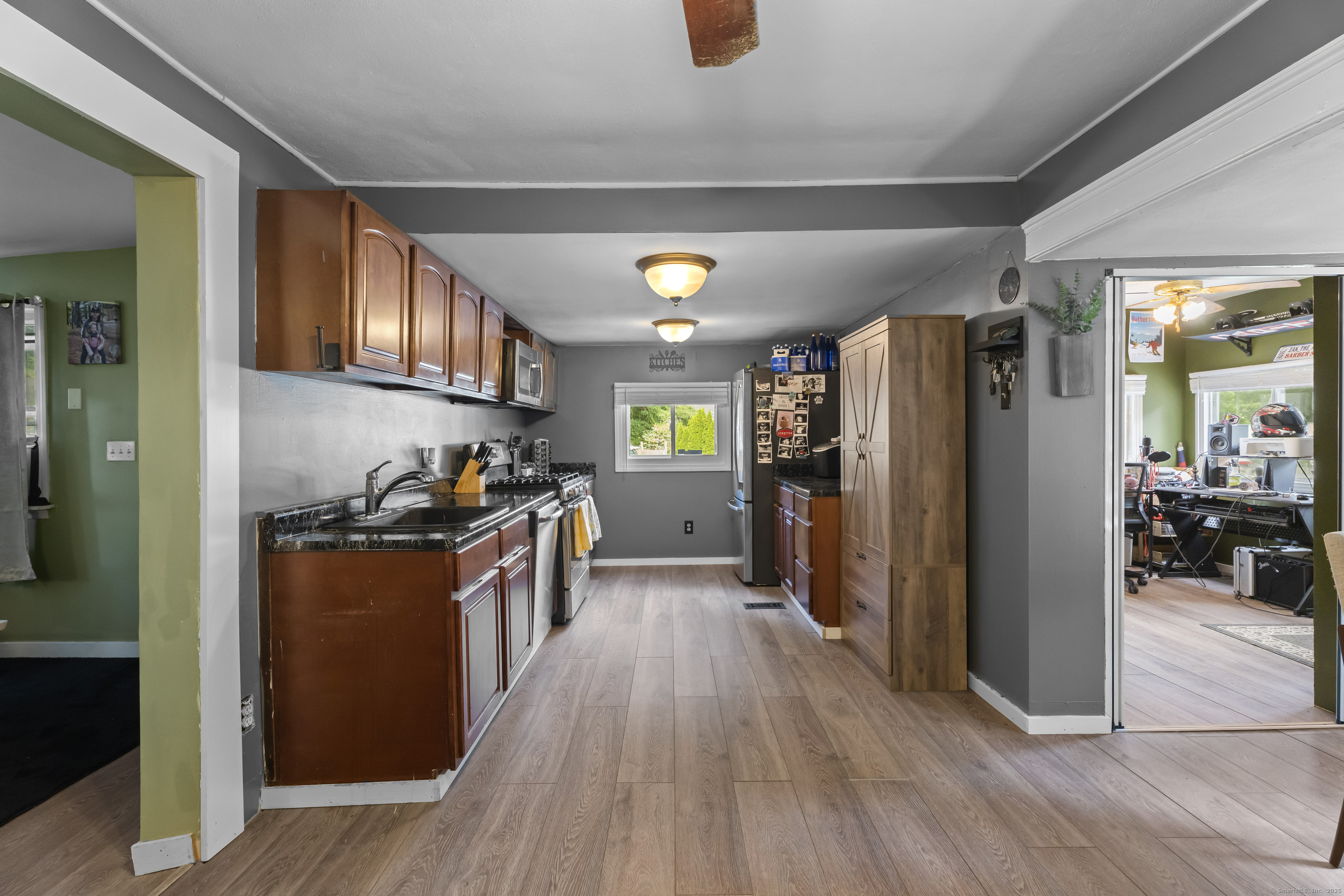 133 West Main Street, Unit MV1 Clinton, CT 06413 - Photo 9 of 36 a kitchen with stainless steel appliances granite countertop a refrigerator a stove and a wooden floors