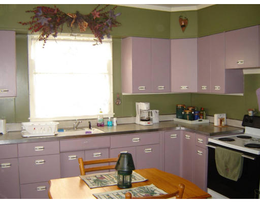 21 Prospect Street Ware, MA 01082 - Photo 6 of 12 a kitchen with a sink a stove and cabinets