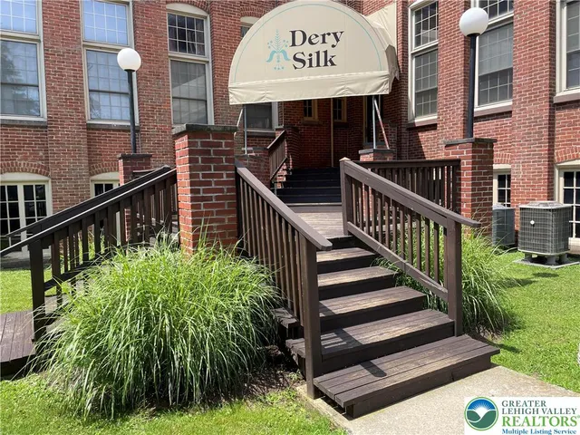 a view of a street with sitting area and front of house