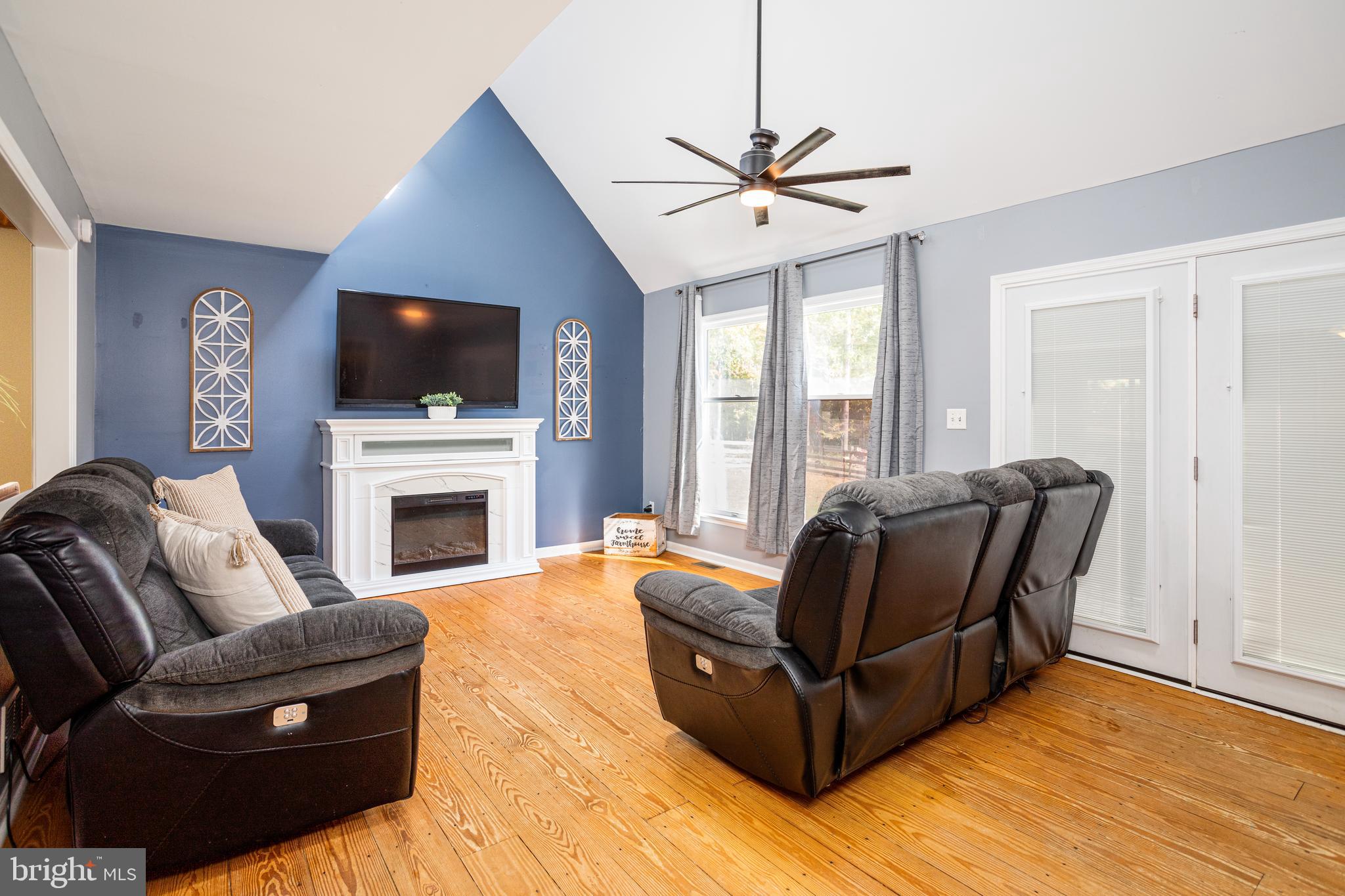 Open, vaulted ceiling family room with fireplace