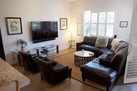 a living room with lots of furniture and a wooden floor