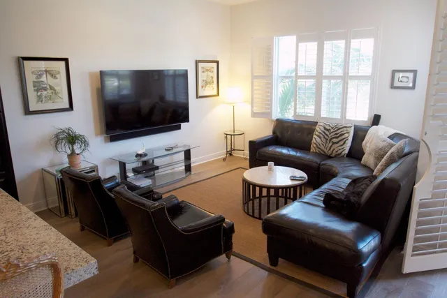 a living room with lots of furniture and a wooden floor
