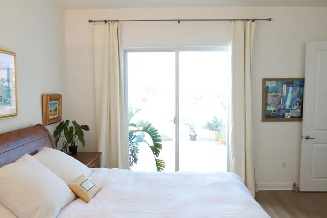 a bed sitting in a bedroom next to a window