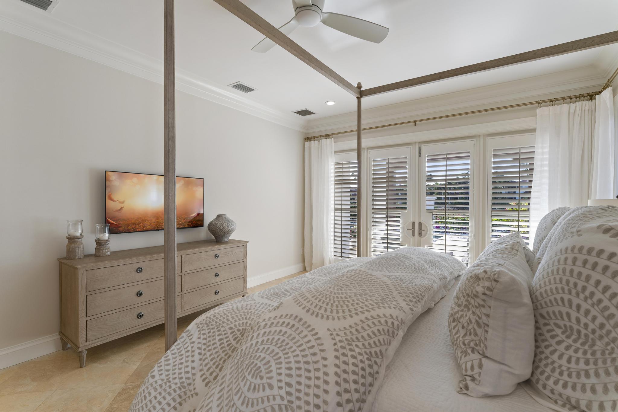 426 Red Hawk Drive Jupiter, FL 33477 - Photo 20 of 70 a bedroom with a bed and a flat screen tv