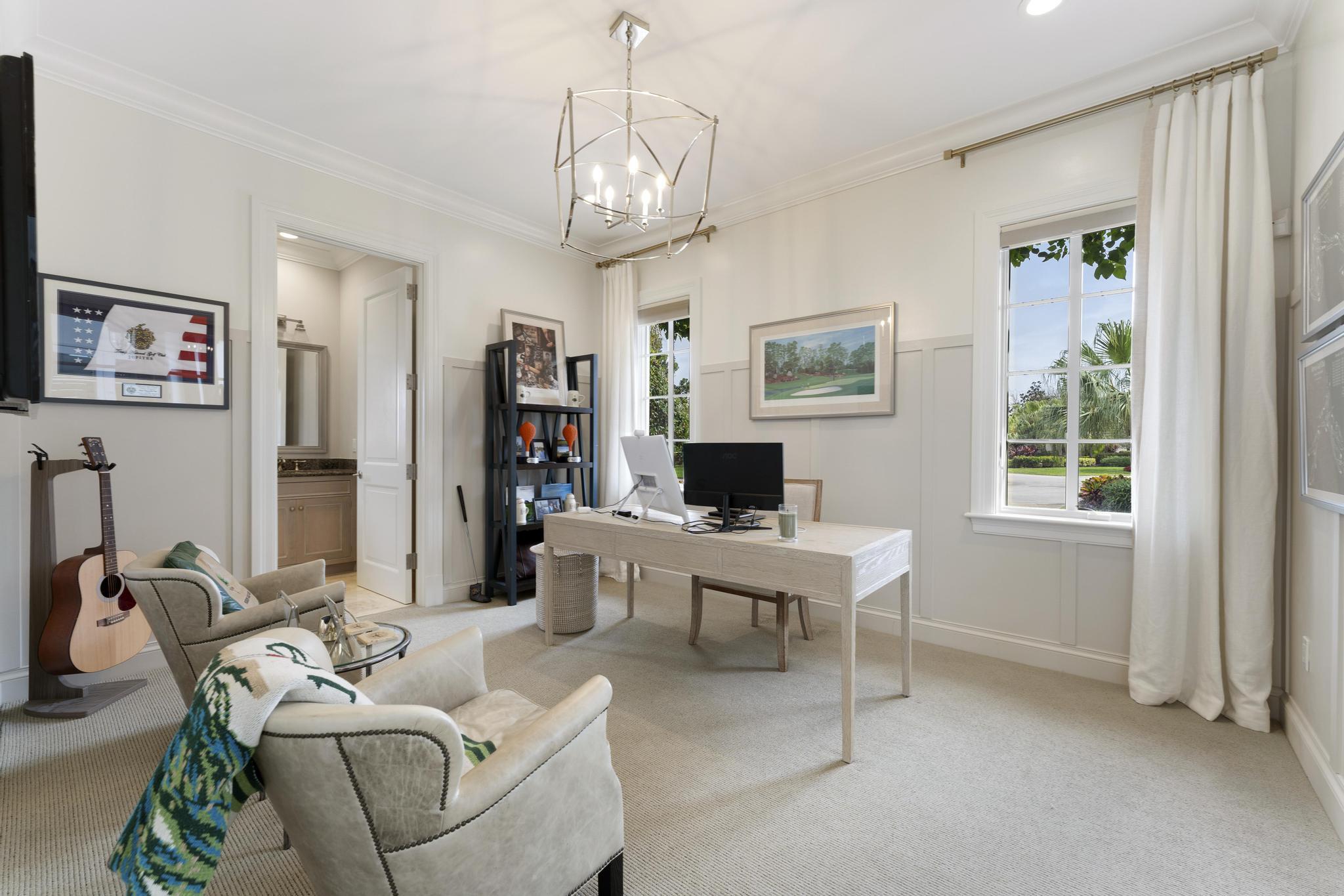 426 Red Hawk Drive Jupiter, FL 33477 - Photo 23 of 70 a living room with furniture a large window and a chandelier