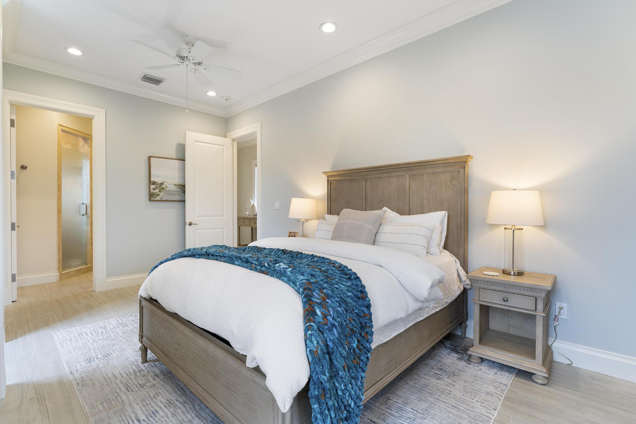 426 Red Hawk Drive Jupiter, FL 33477 - Photo 32 of 70 a spacious bedroom with a bed and a lamp