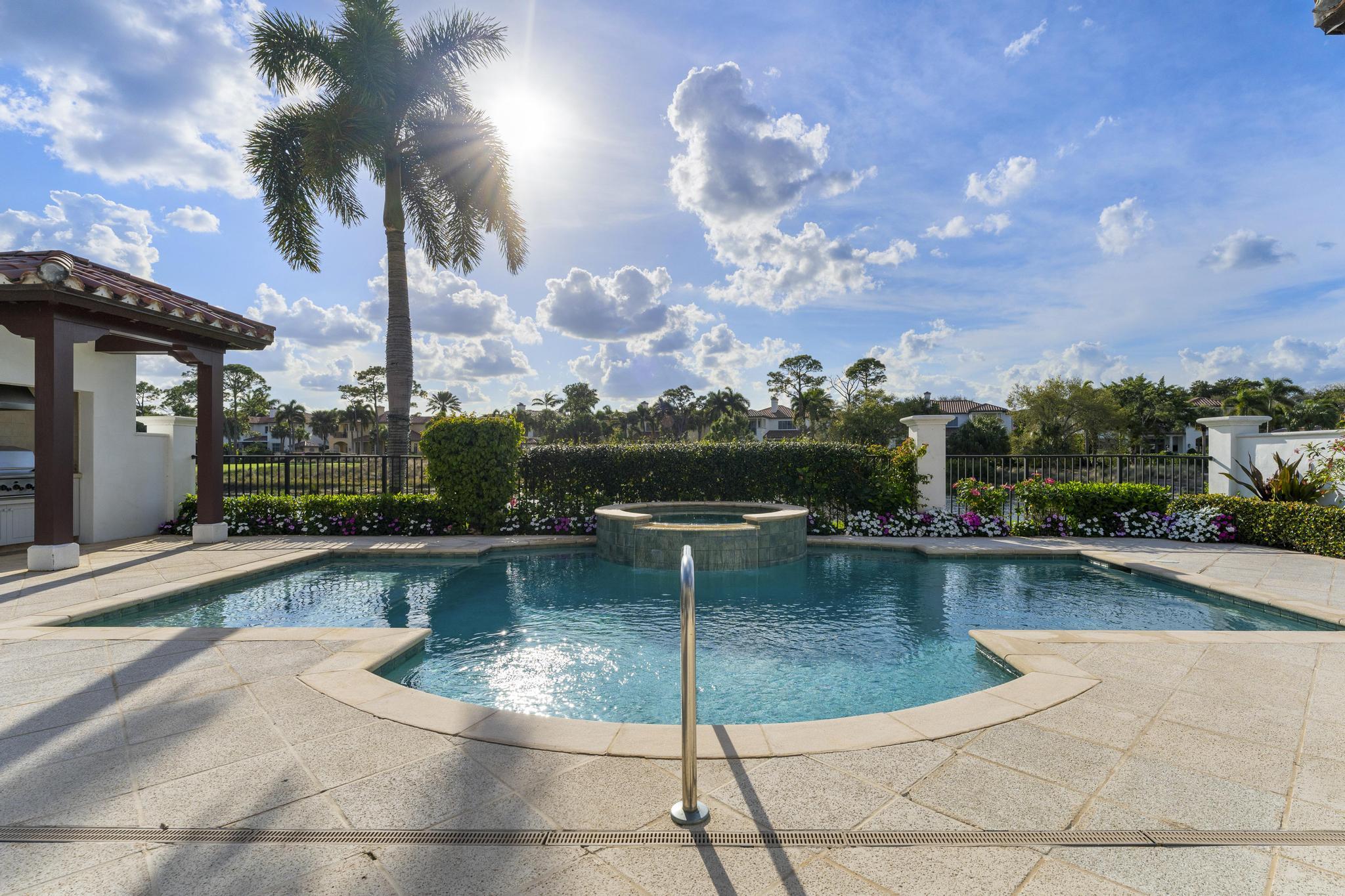 426 Red Hawk Drive Jupiter, FL 33477 - Photo 35 of 70 a view of a swimming pool with a table and chair in the patio