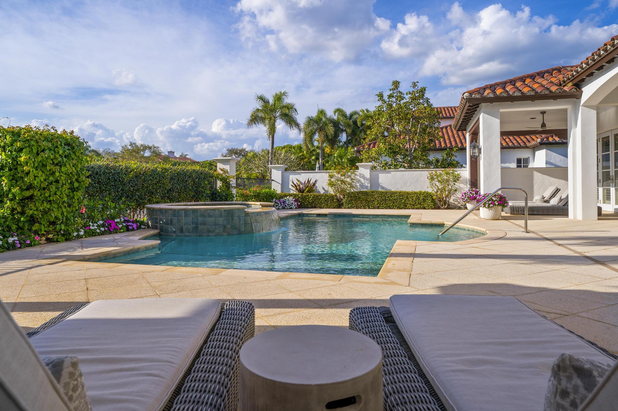 426 Red Hawk Drive Jupiter, FL 33477 - Photo 37 of 70 an outdoor sitting area with swimming pool in front of it