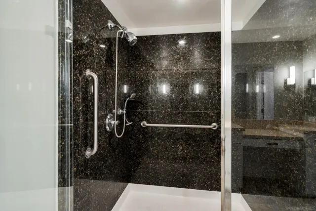 a bathroom with a glass shower door