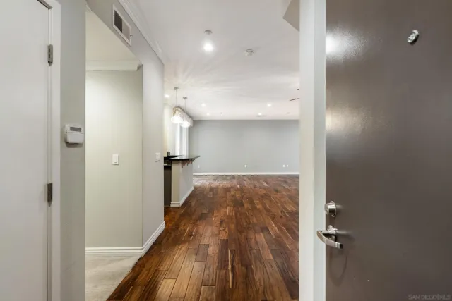 a view of hallway with stairs and wooden floor