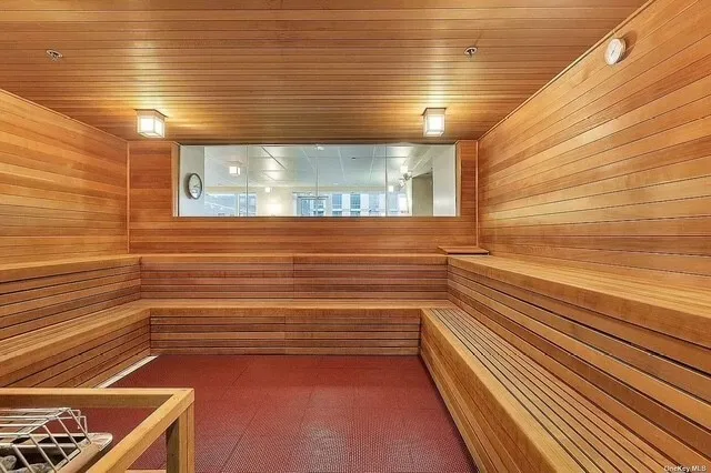 a view of a room with lots of furniture and a window