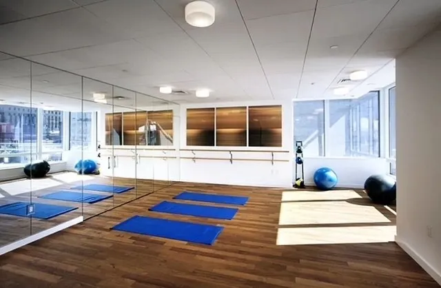 a living room with stainless steel appliances kitchen island granite countertop furniture and a large window