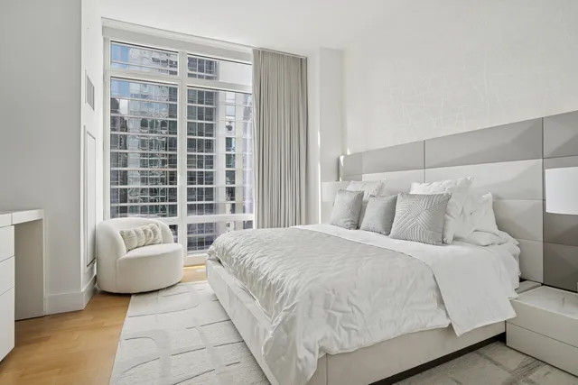 a view of a dining room with furniture a chandelier and wooden floor