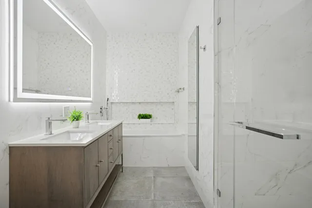 a bedroom with a bed and a couch next to a window