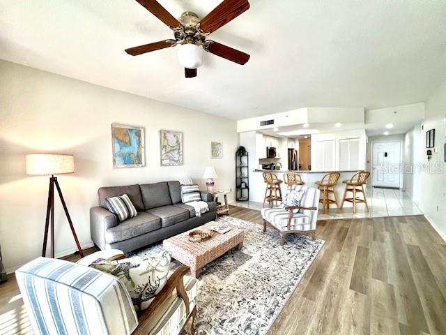 3020 Matecumbe Key Road, Unit 103 Punta Gorda, FL 33955 - Photo 13 of 55 a living room with furniture and a wooden floor