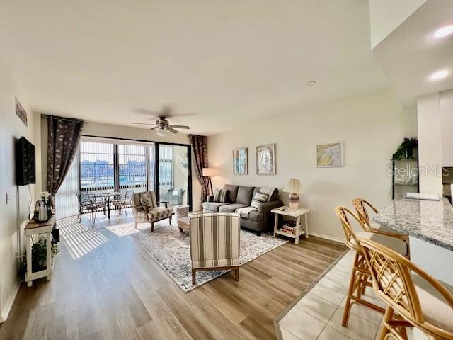 3020 Matecumbe Key Road, Unit 103 Punta Gorda, FL 33955 - Photo 18 of 55 a living room with furniture large window and wooden floor