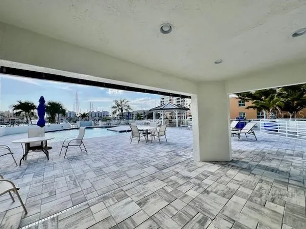 a view of a patio with dining table and chairs