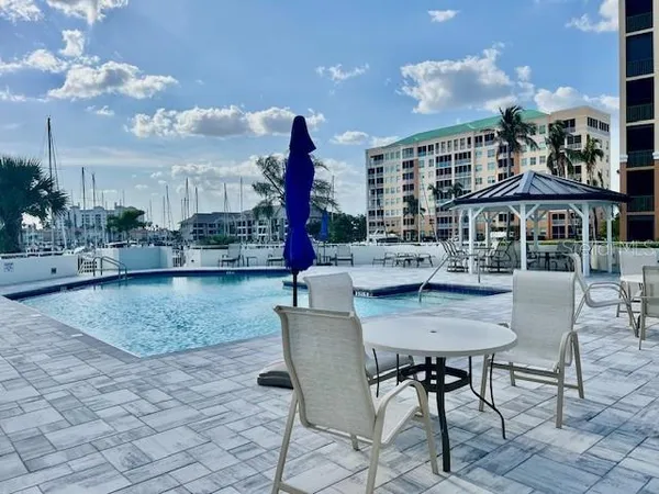 a view of a patio with dining table and chairs and potted plants