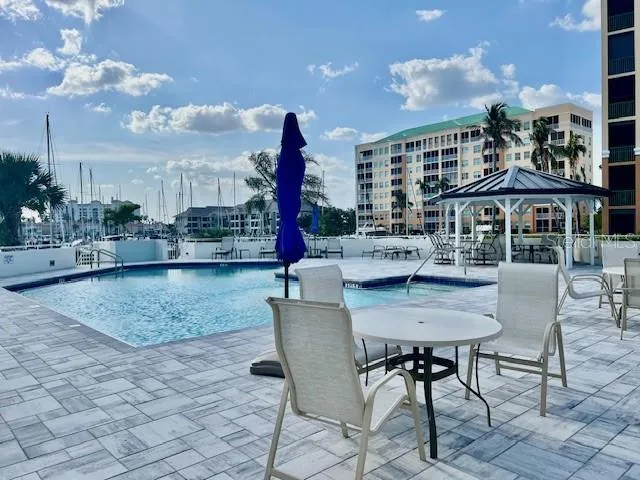 a view of a patio with dining table and chairs and potted plants