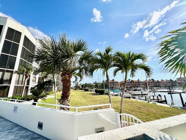 3020 Matecumbe Key Road, Unit 103 Punta Gorda, FL 33955 - Photo 9 of 55 a view of a swimming pool with a table and chairs
