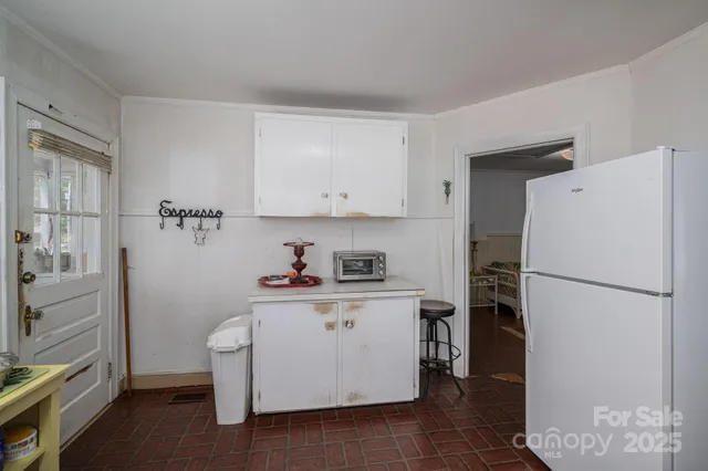 a white refrigerator freezer sitting inside of a kitchen