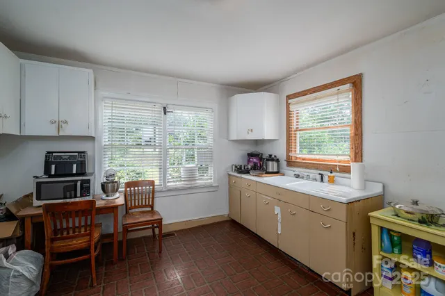 a view of a kitchen with a window and cabinets