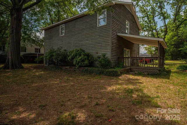 a view of a house with a window and wooden fence