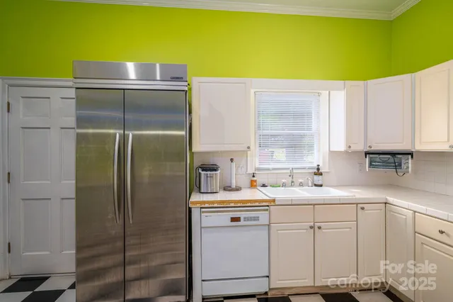 a kitchen with a checkered floor and black appliances