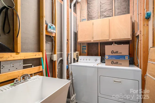 a kitchen with stainless steel appliances a sink a counter space and cabinets