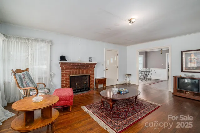 a living room with furniture a fireplace and a table