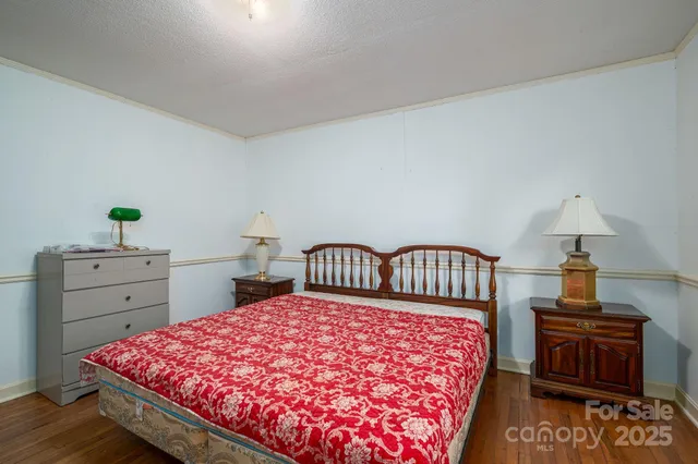 a bedroom with a bed and a dresser in it