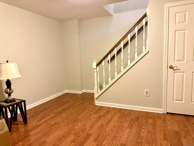 a view of an entryway with wooden floor
