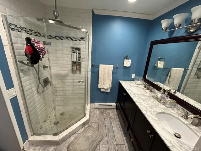 a bathroom with a granite countertop sink a toilet and shower