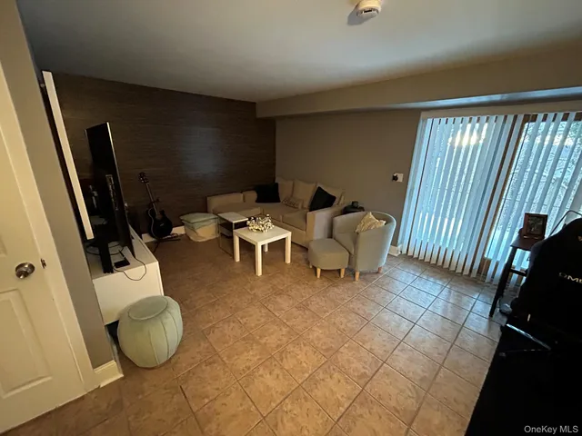 a living room with couches and a flat screen tv