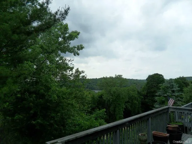 a view of a balcony with an outdoor seating