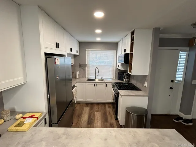 a kitchen with a sink appliances and cabinets