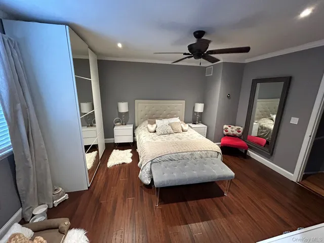 a bedroom with a bed and a mirror