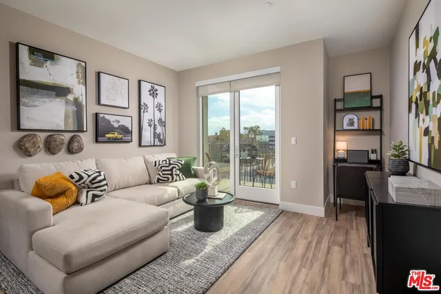 a living room with furniture and a floor to ceiling window