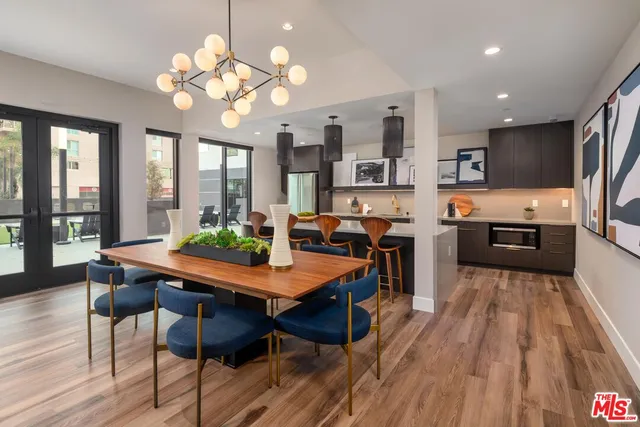 a view of a dining room with furniture large window and wooden floor