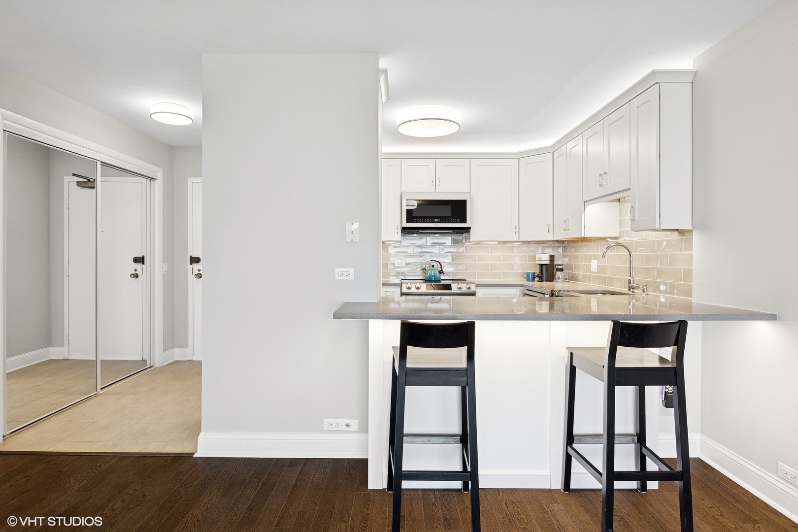 5415 North Sheridan Road, Unit 3004 Chicago, IL 60640 - Photo 6 of 26 a kitchen with kitchen island granite countertop a sink cabinets and refrigerator