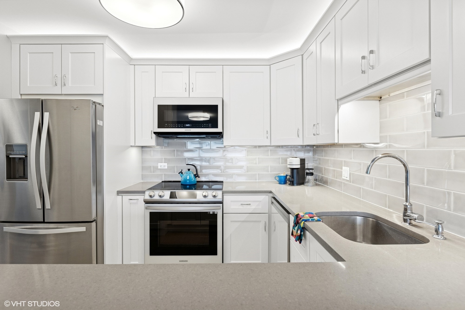 5415 North Sheridan Road, Unit 3004 Chicago, IL 60640 - Photo 8 of 26 a kitchen with stainless steel appliances a stove a sink a refrigerator and cabinets