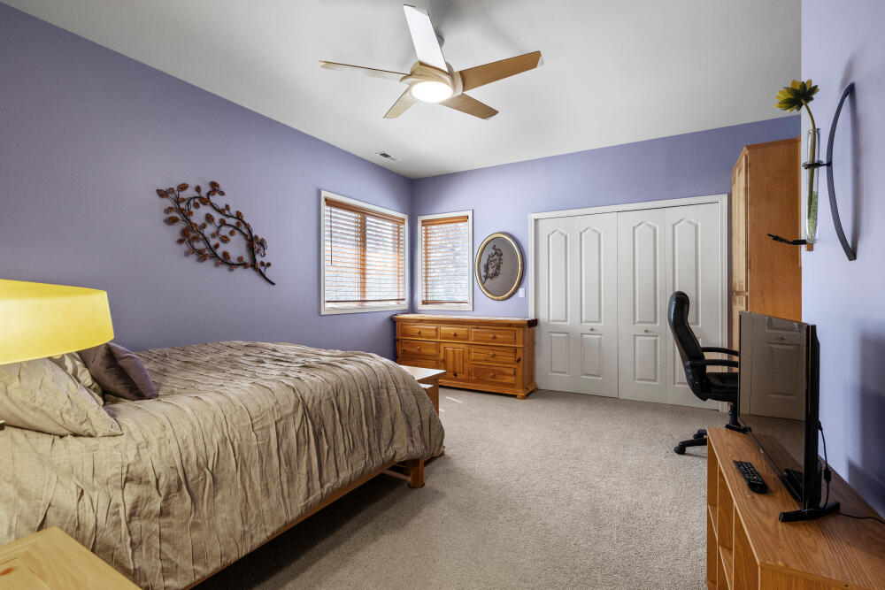11629 Merganser Road Klamath Falls, OR 97601 - Photo 49 of 50 a bedroom with a bed and a chandelier