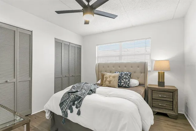 a bedroom with a bed and wooden floor