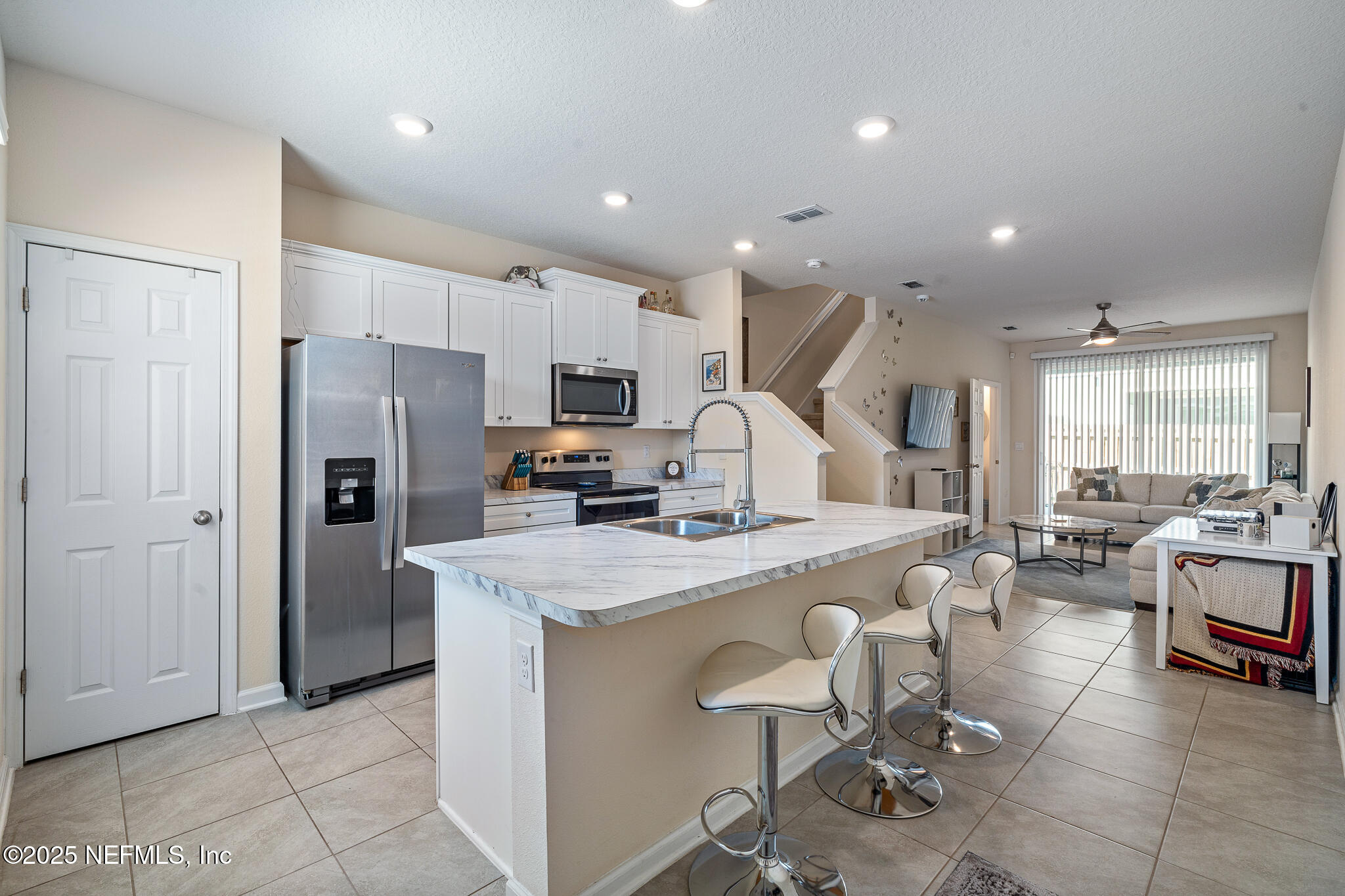 113 Red House Cir Street St. Augustine, FL 32084 - Photo 2 of 40 a large kitchen with a table chairs refrigerator and cabinets
